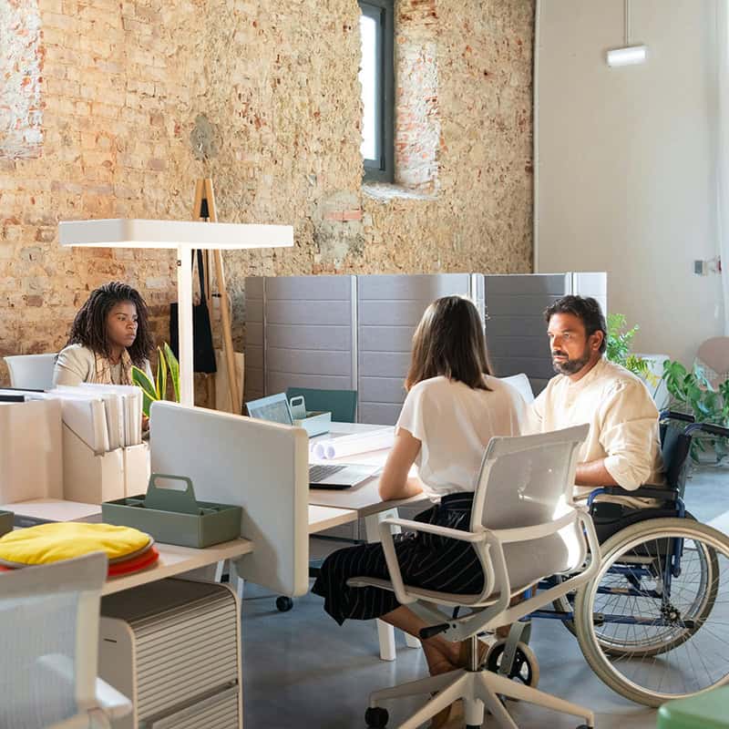 Diverse team collaborating in modern office space, discussing strategies for local SEO and digital marketing.